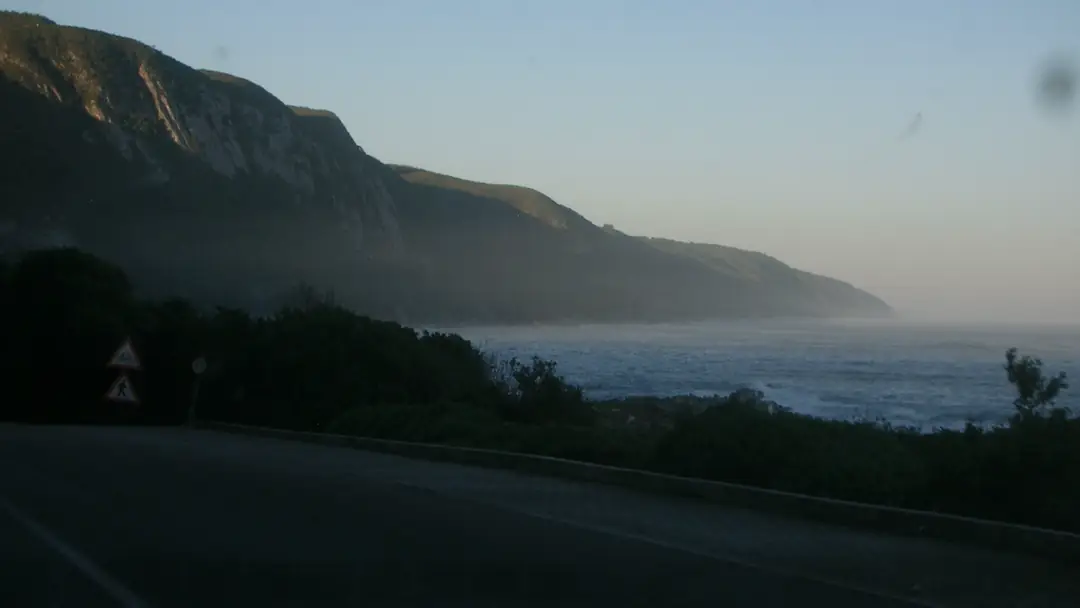 An open coastal road at first light